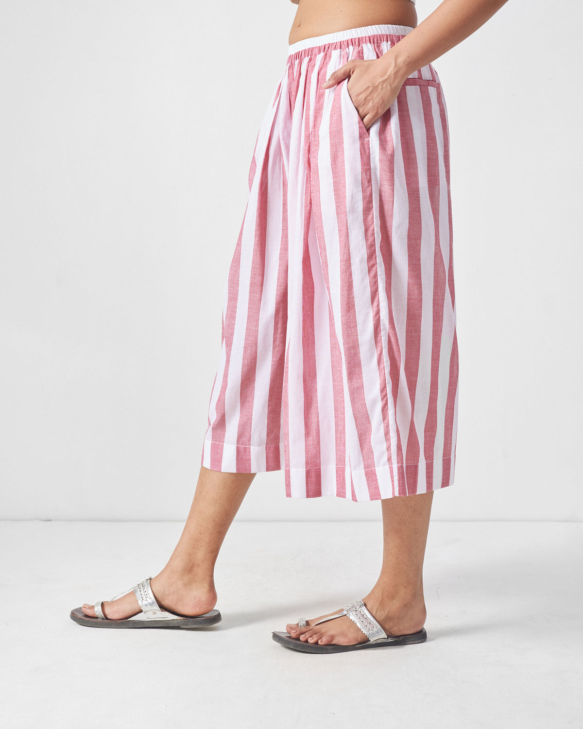 Side view of red and white striped Aoi Pants with a wide cropped leg.