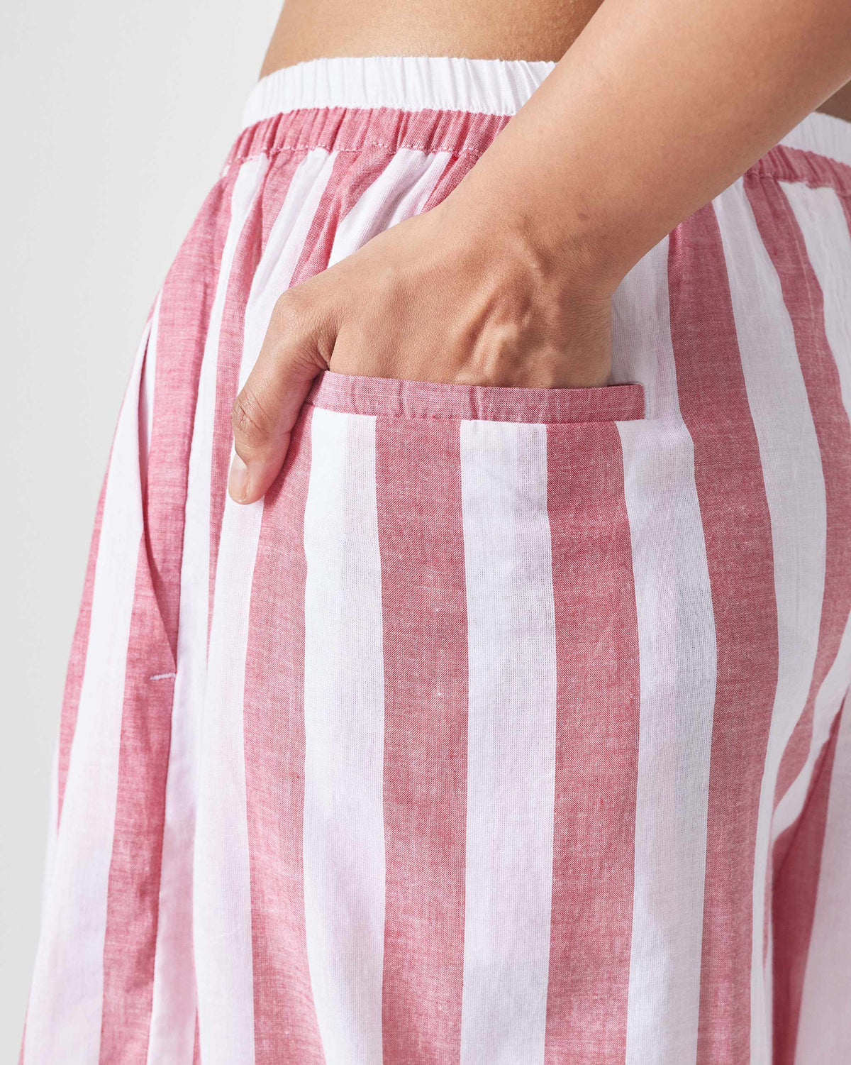 Close-up of red and white striped Aoi Pants showing a side pocket.