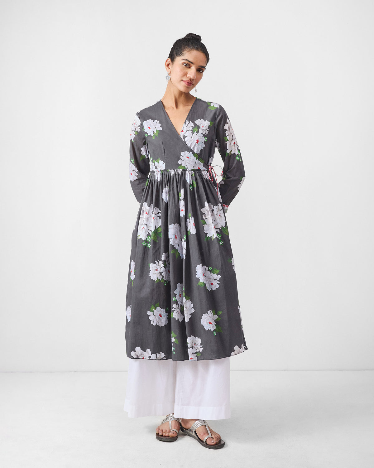 Person wearing a charcoal gathered angrakha with ivory floral print.