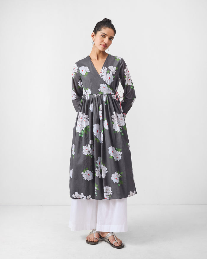 Person wearing a charcoal gathered angrakha with ivory floral print.