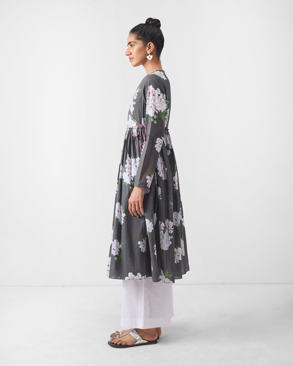 Side view of a charcoal floral angrakha worn by a person.