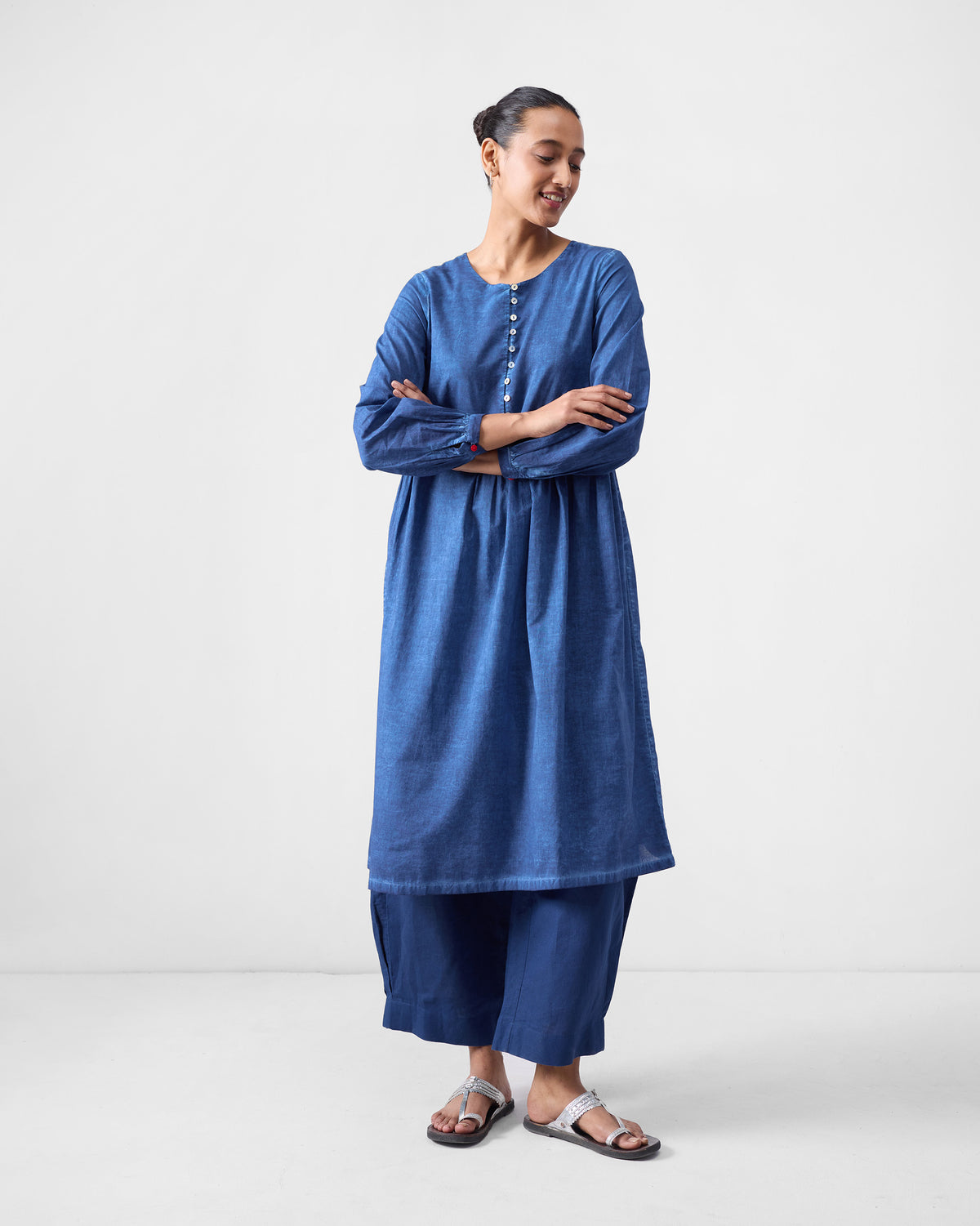 Person wearing a blue Geisha Kurta with front buttons and a flared hem.
