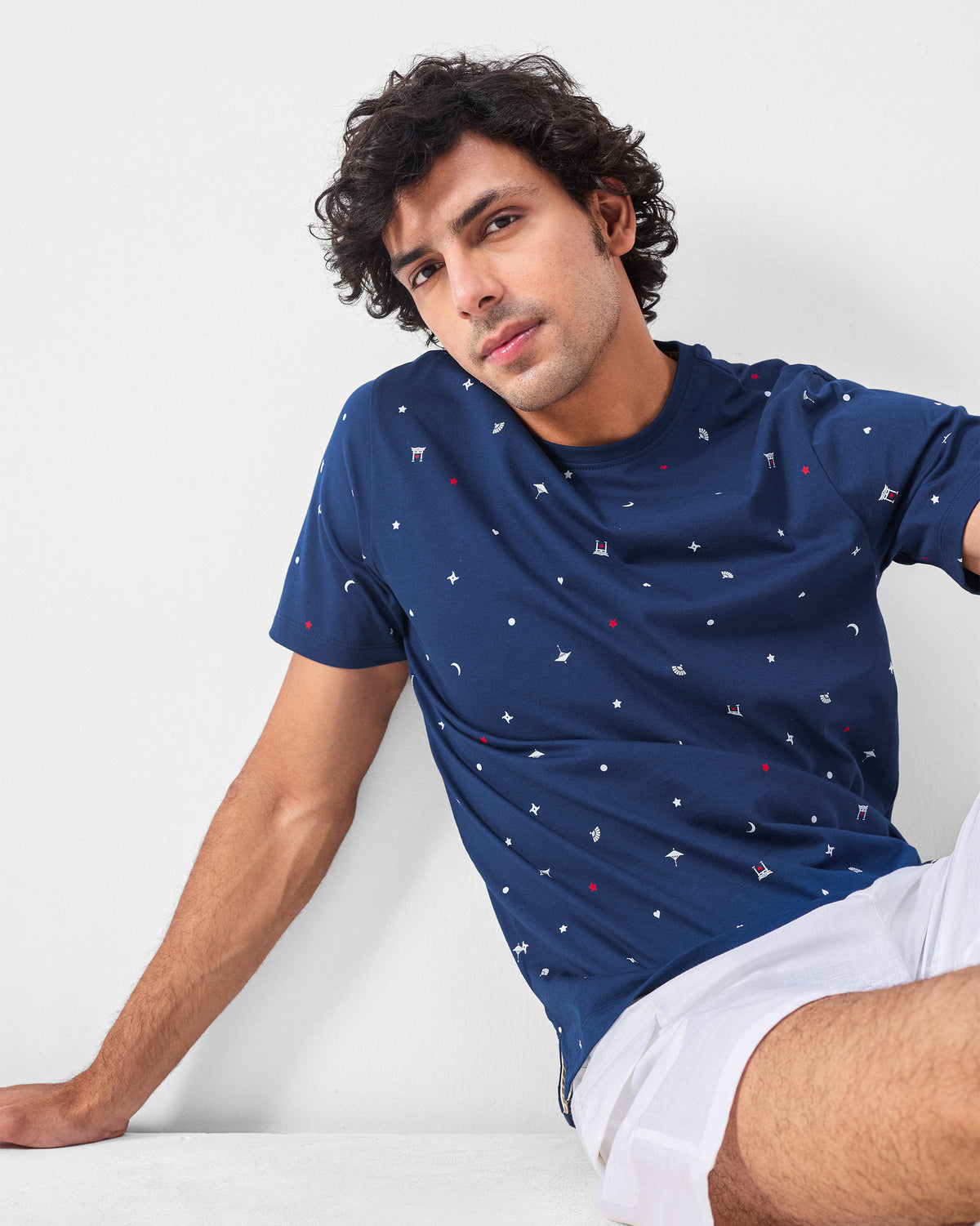 Person wearing a navy Haruto t-shirt with a scattered Japanese print.