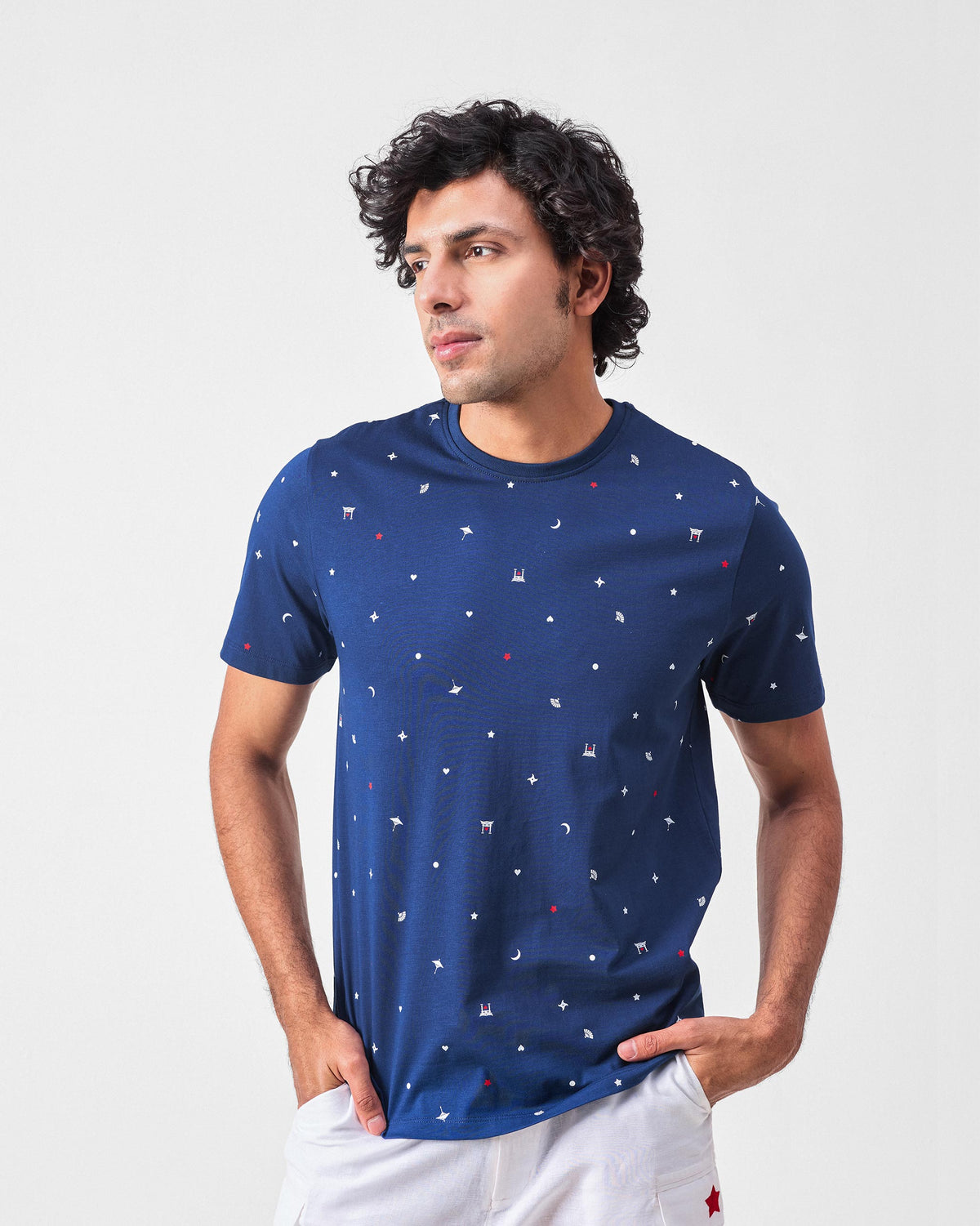 Person wearing a navy Haruto t-shirt with an all-over Japanese print.