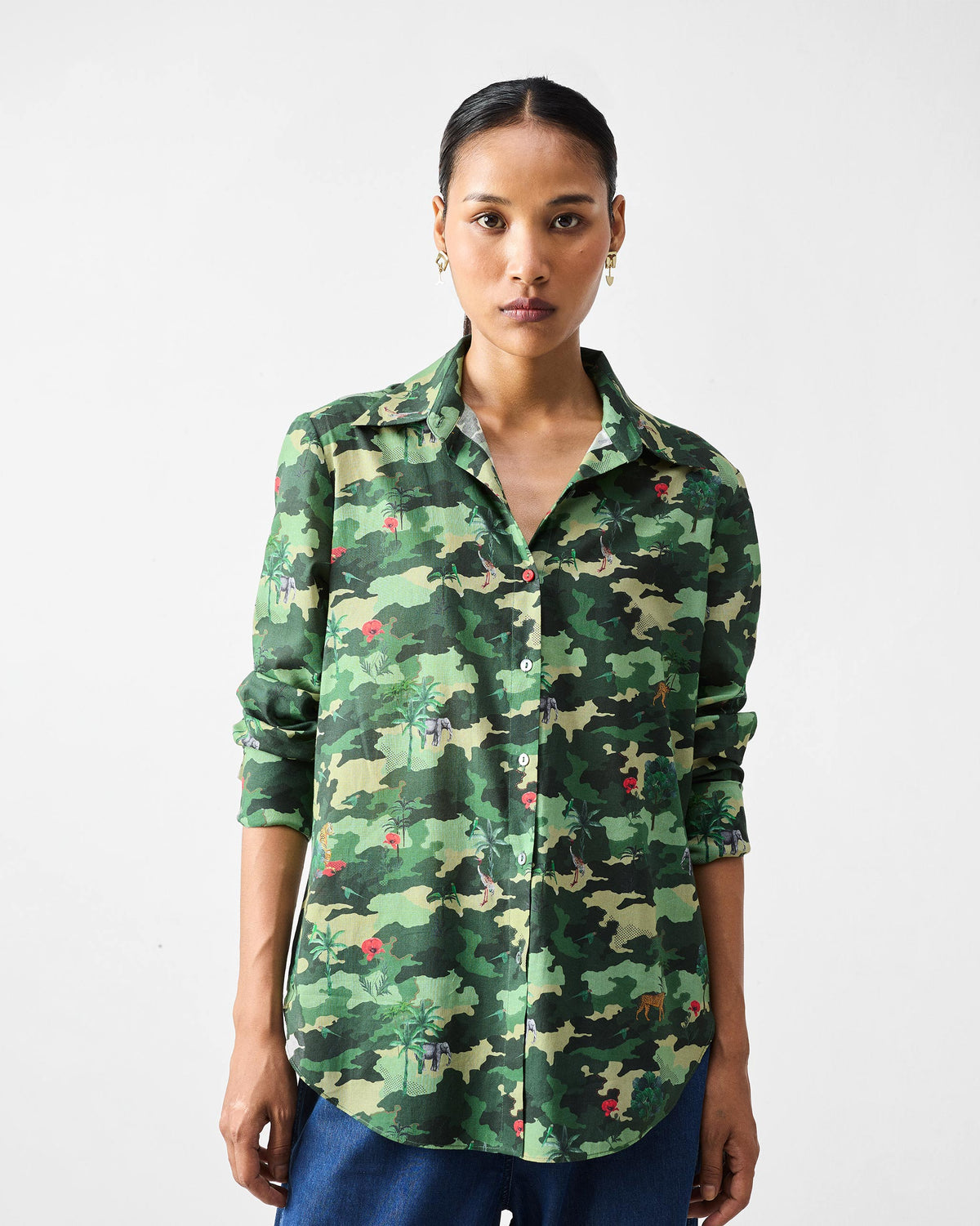 Person wearing a green camouflage Tropico Shirt with small animal motifs.
