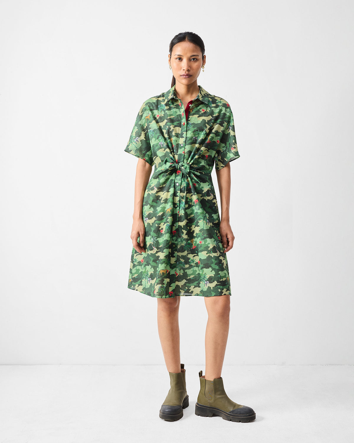 Person wearing a green printed Alappuzha Shirt Dress with a waist knot.