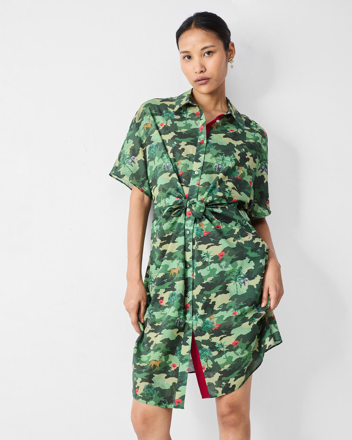 Person wearing a green camouflage Alappuzha Shirt Dress with a tied waist.