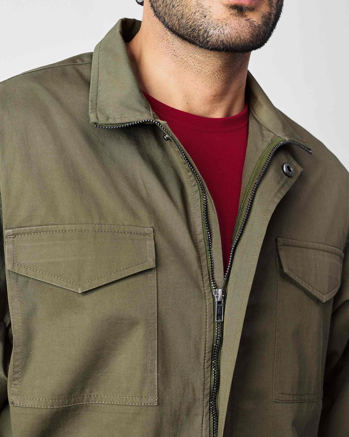Olive utility jacket with a zipper and flapped chest pockets.