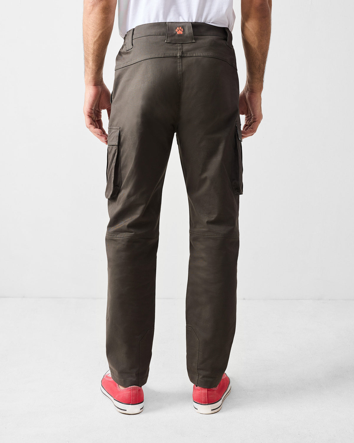 Back of deep olive Boscage pants with cargo pockets and an orange paw mark.