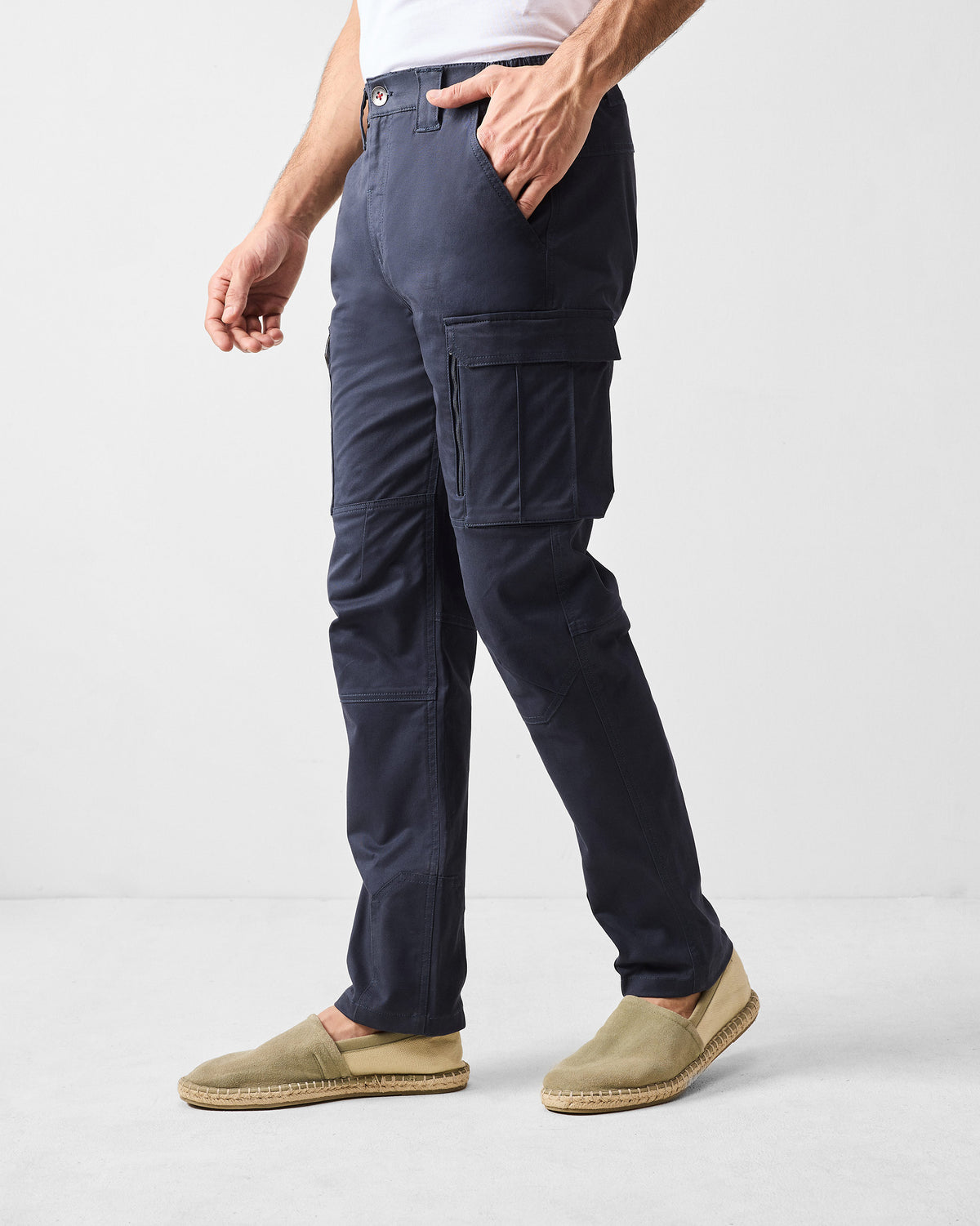 Side view of navy Boscage cargo pants showing a flap cargo pocket.