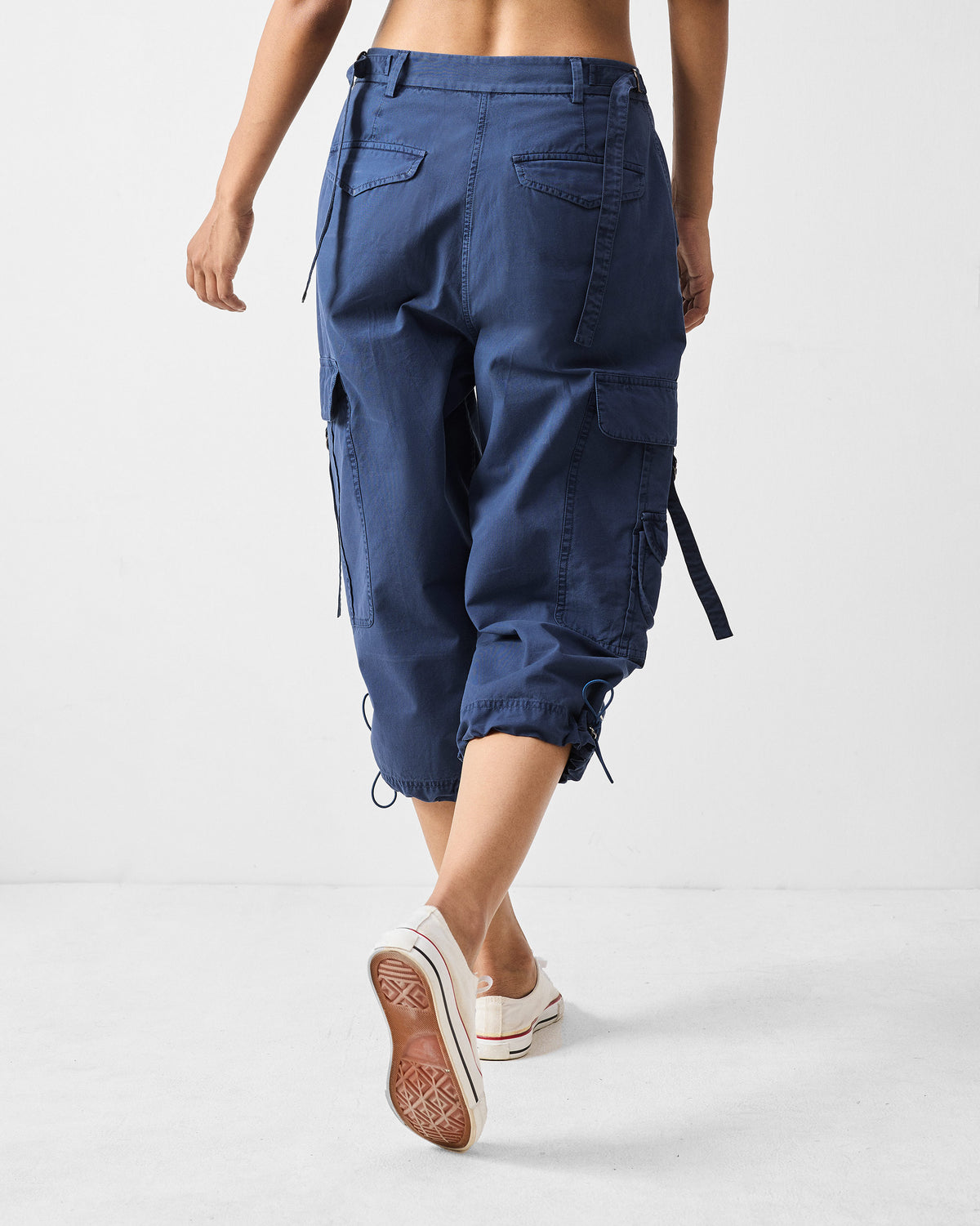 Back of navy Vellore capris with flap pockets and drawstring hems.