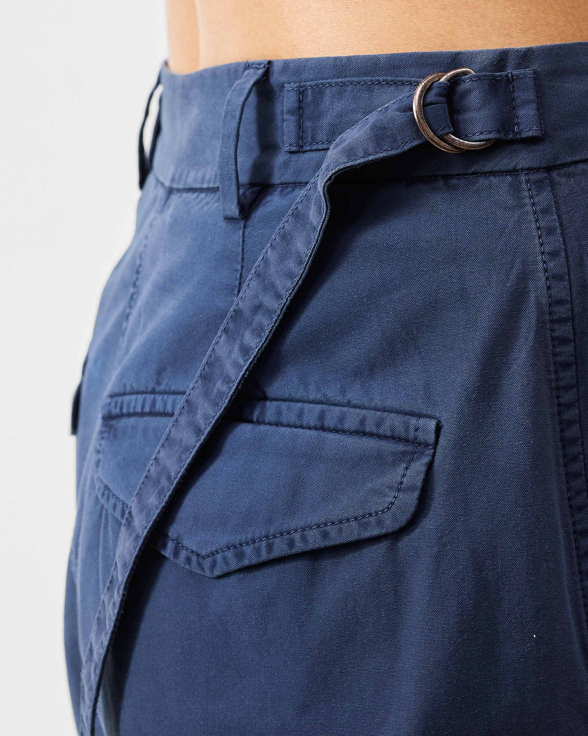 Close-up of the side waist cinch strap on navy Vellore capris.