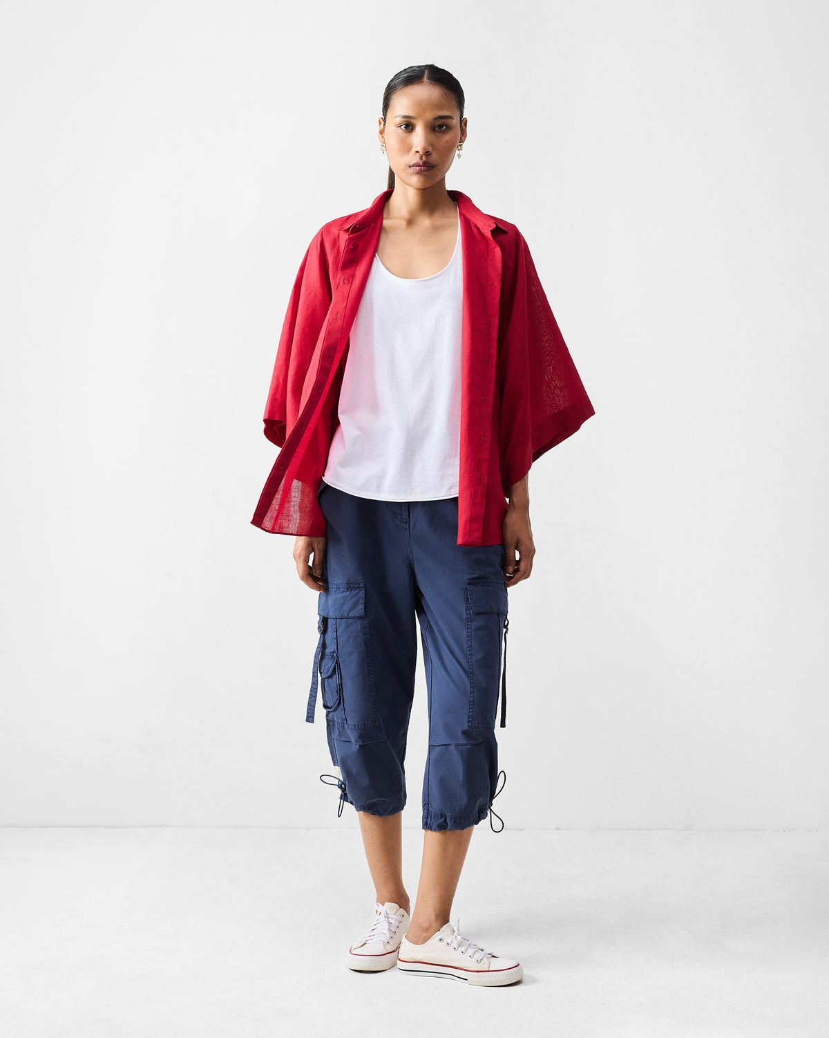 Navy Vellore cargo capris with drawstring hems worn with white sneakers.