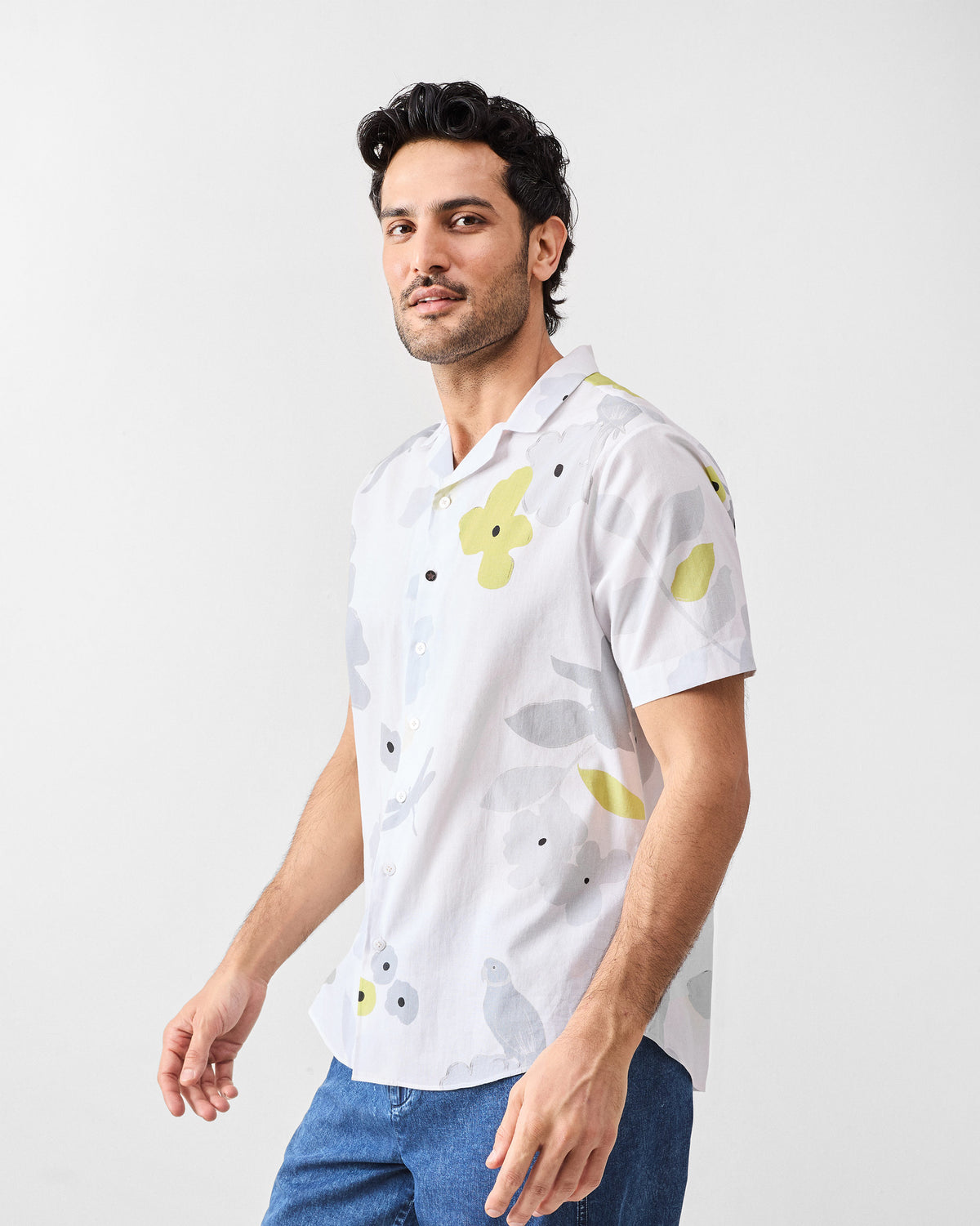 Three-quarter view of a white Mistari Shirt with a lime and grey floral print.