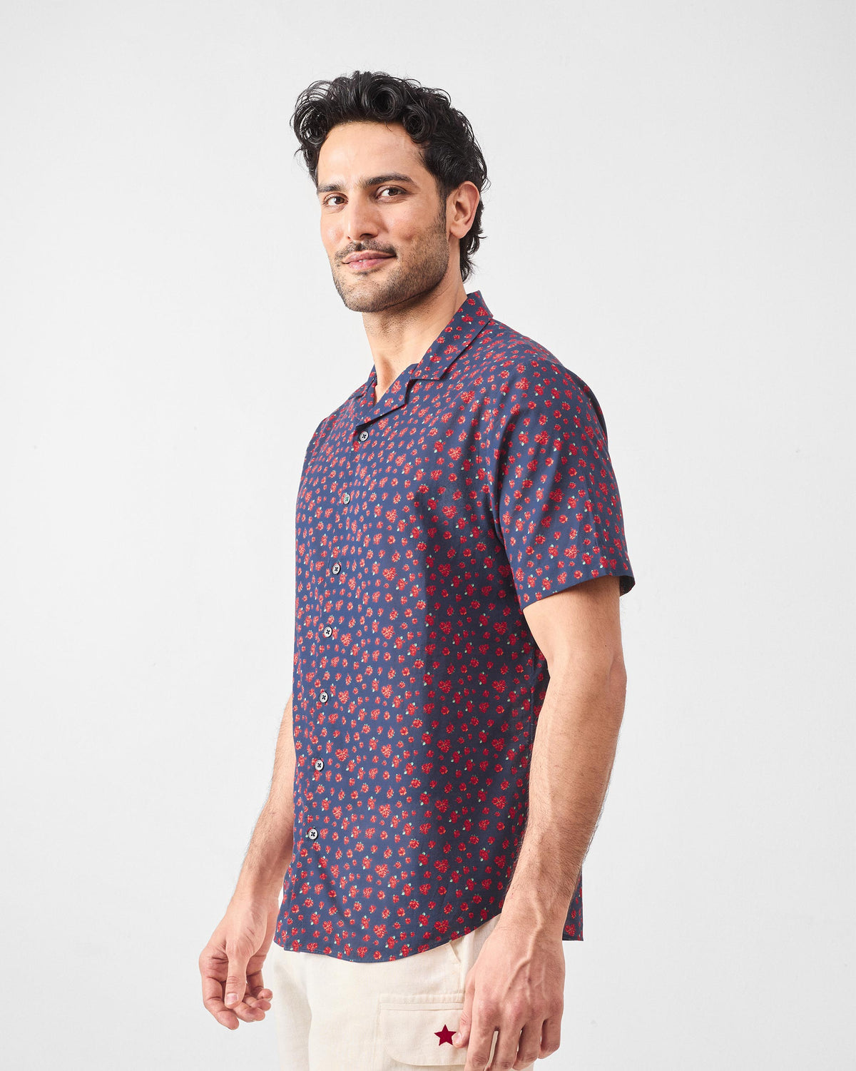 Navy Mistari shirt with red rose print worn at a three-quarter angle.