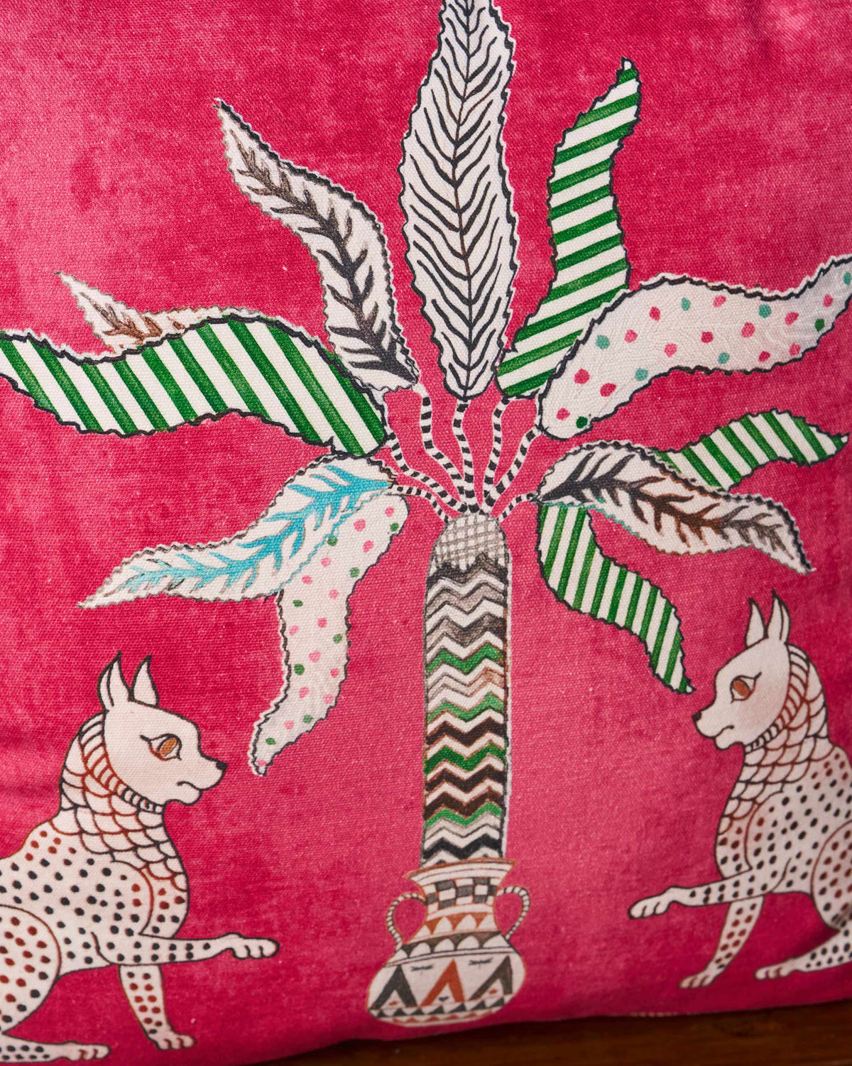 Close-up of the Leopard Palm cushion cover showing a striped palm and two leopards.