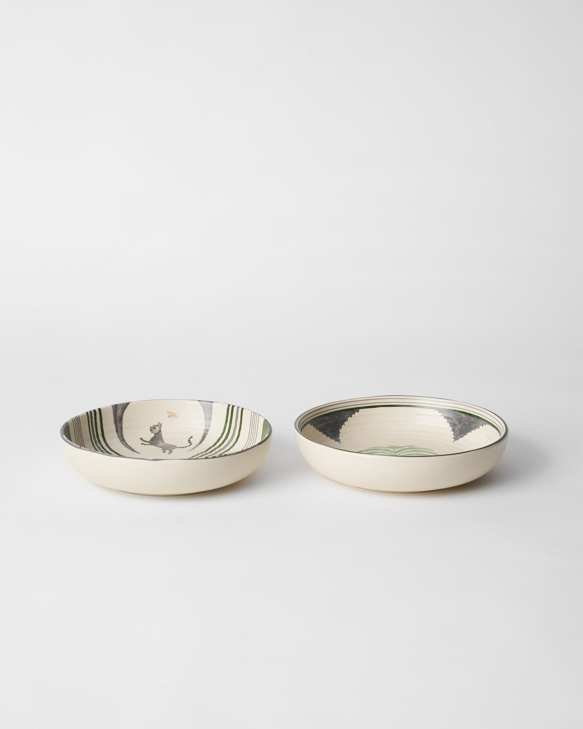Pair of Indus Shallow Bowls with leopard and green geometric prints.