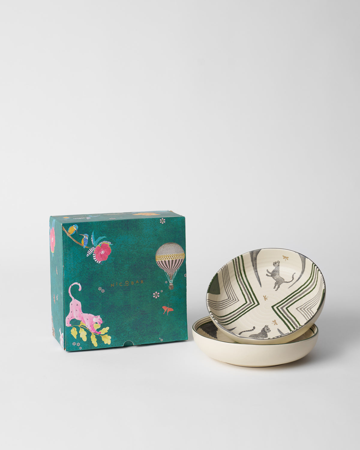 Indus Shallow Bowls stacked beside a teal Nicobar gift box.