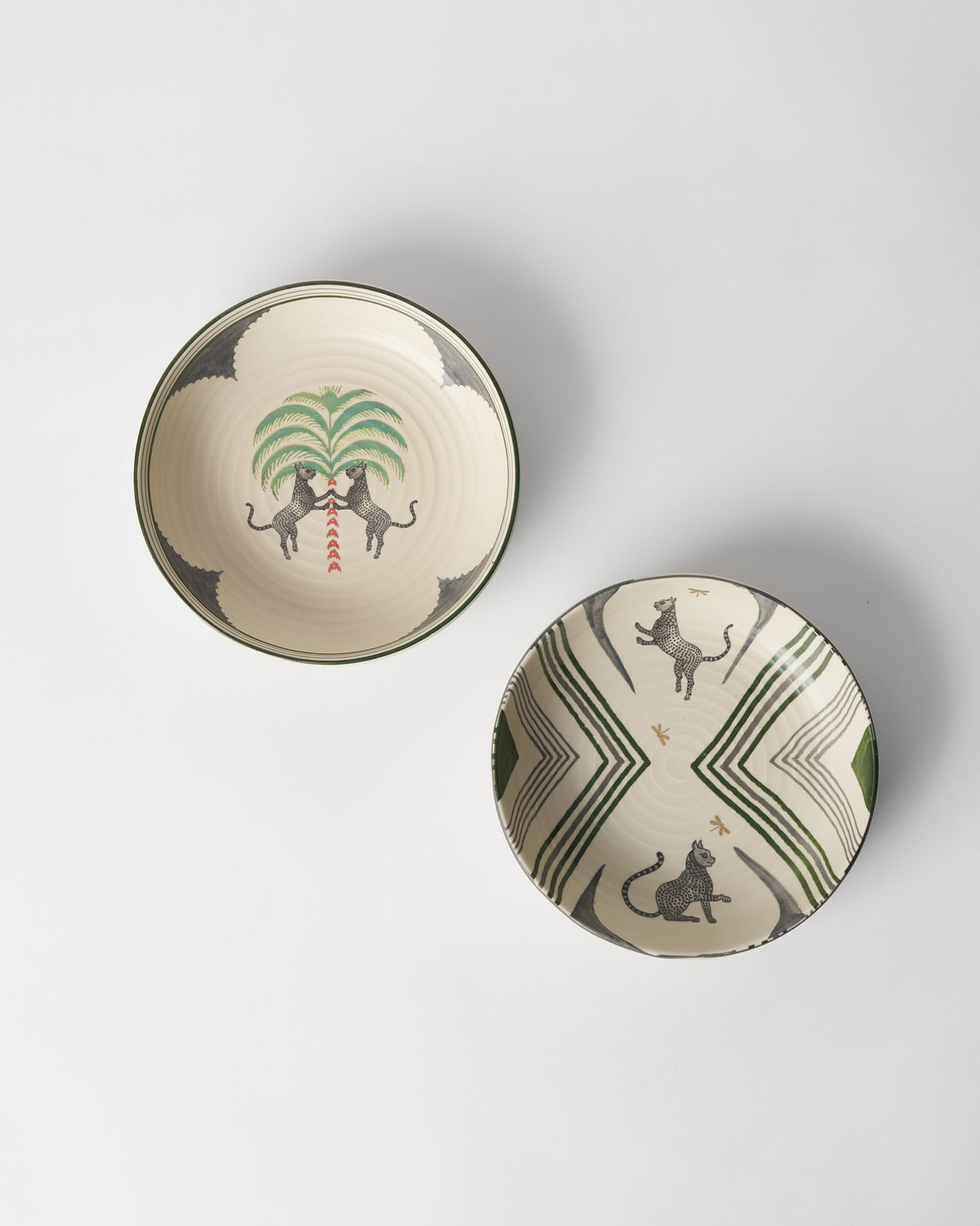 Overhead view of Indus Shallow Bowls with leopards, palms, and dragonflies.