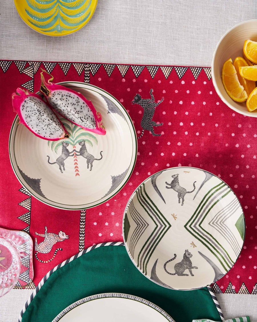 Indus bowls holding dragon fruit on a red patterned runner