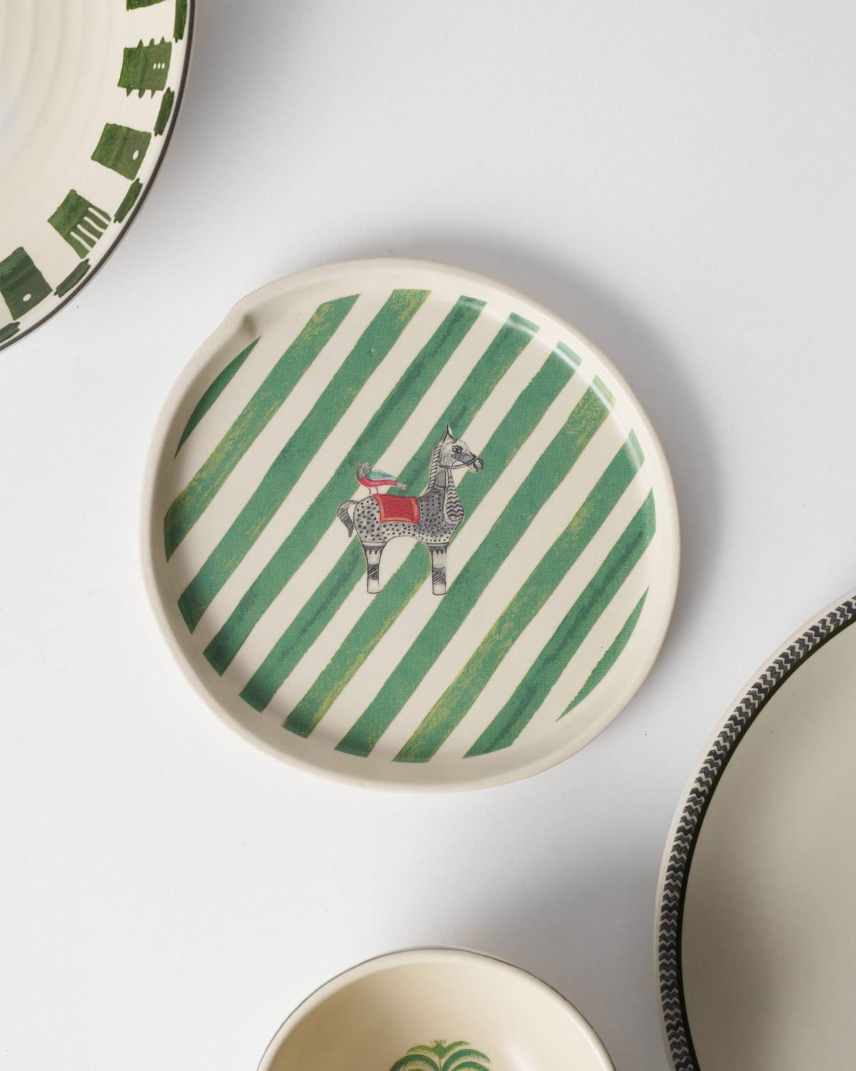 Indus Dessert Plate in a table setting, seen from above with other plates.