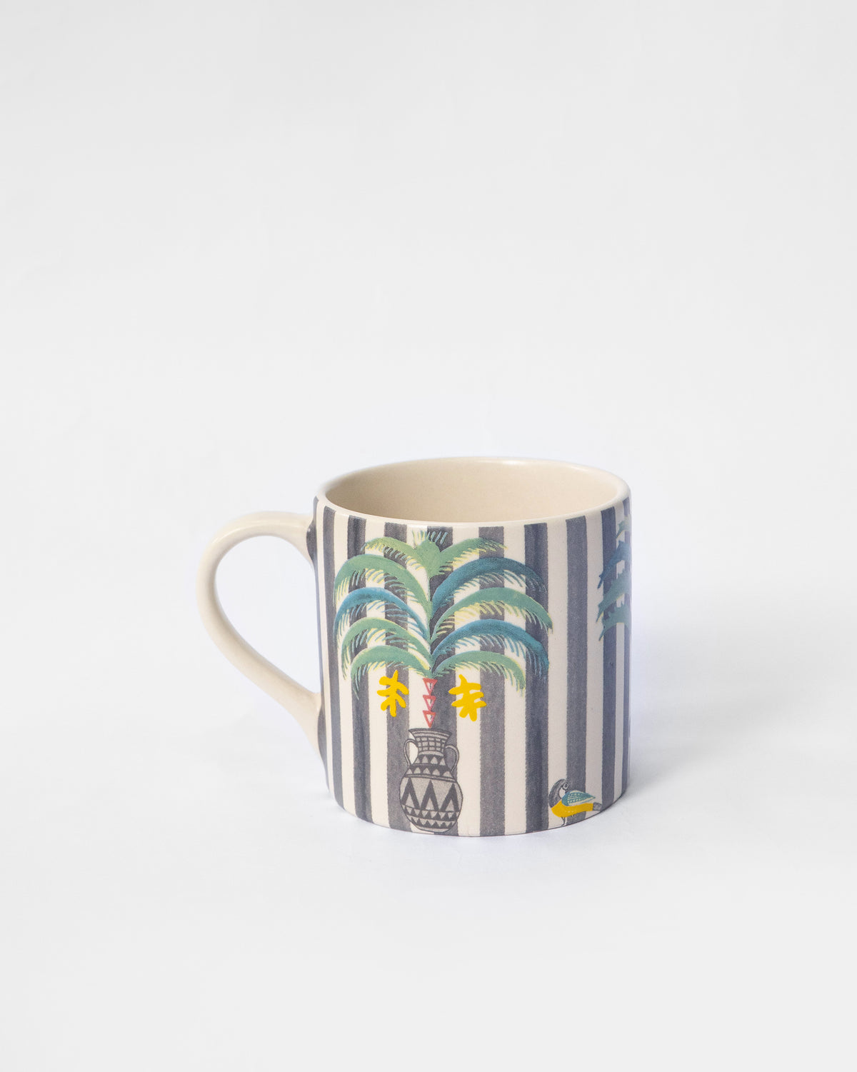 Side view of a striped Indus Straight Mug with a palm motif.