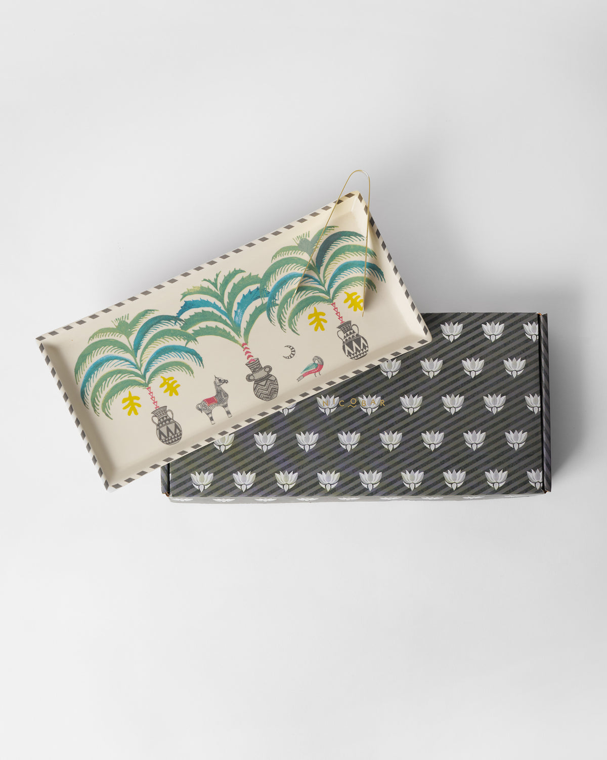 Indus cookie tray resting on its charcoal striped Nicobar gift box.