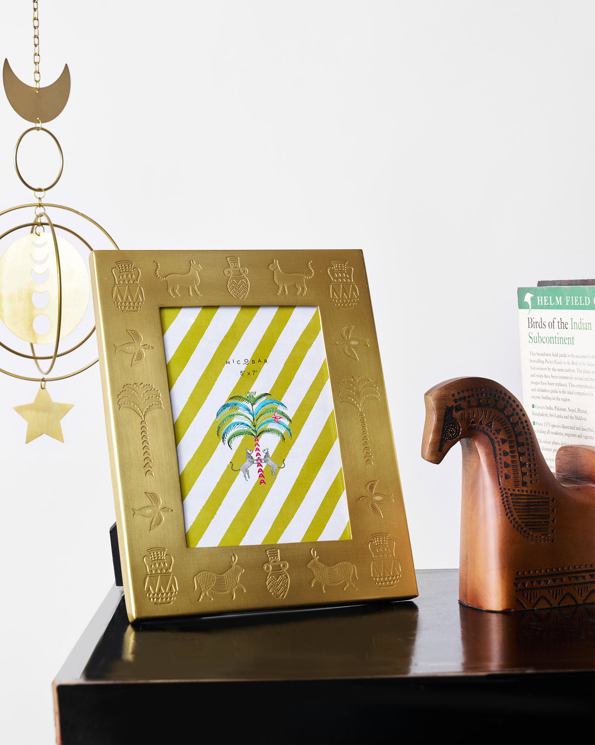 Indus photo frame with embossed motifs styled on a console.