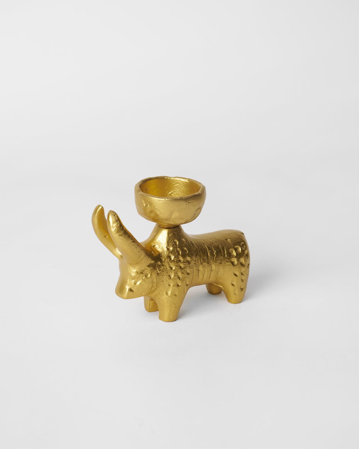 Three-quarter view of gold Bull Tealight Holder showing its curved horns.