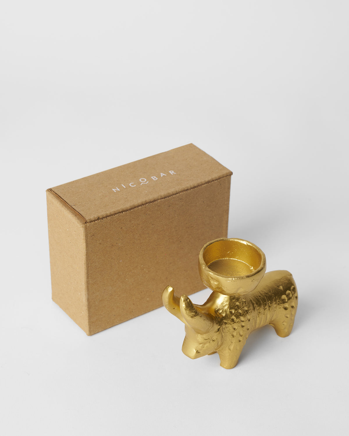 Bull Tealight Holder beside a Nicobar kraft box.