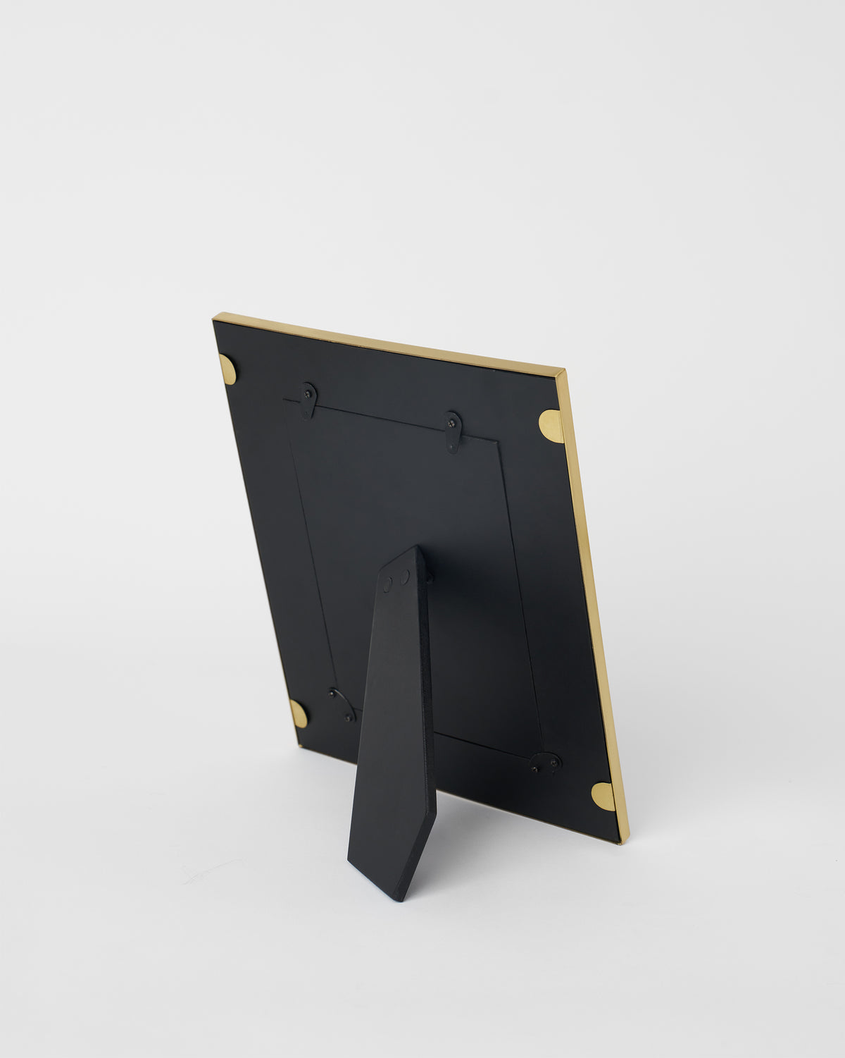 Back of a gold Anara photo frame with a black easel stand.