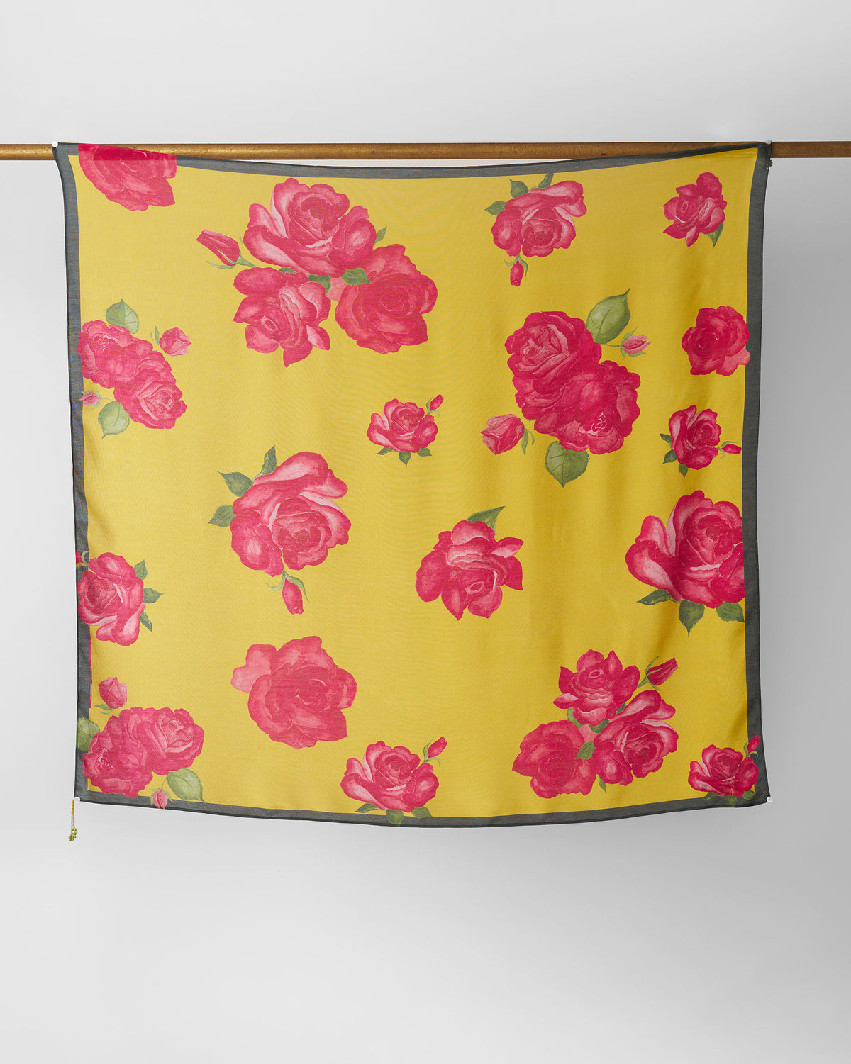 Kesar scarf hung flat, showing pink roses on yellow with a grey border.
