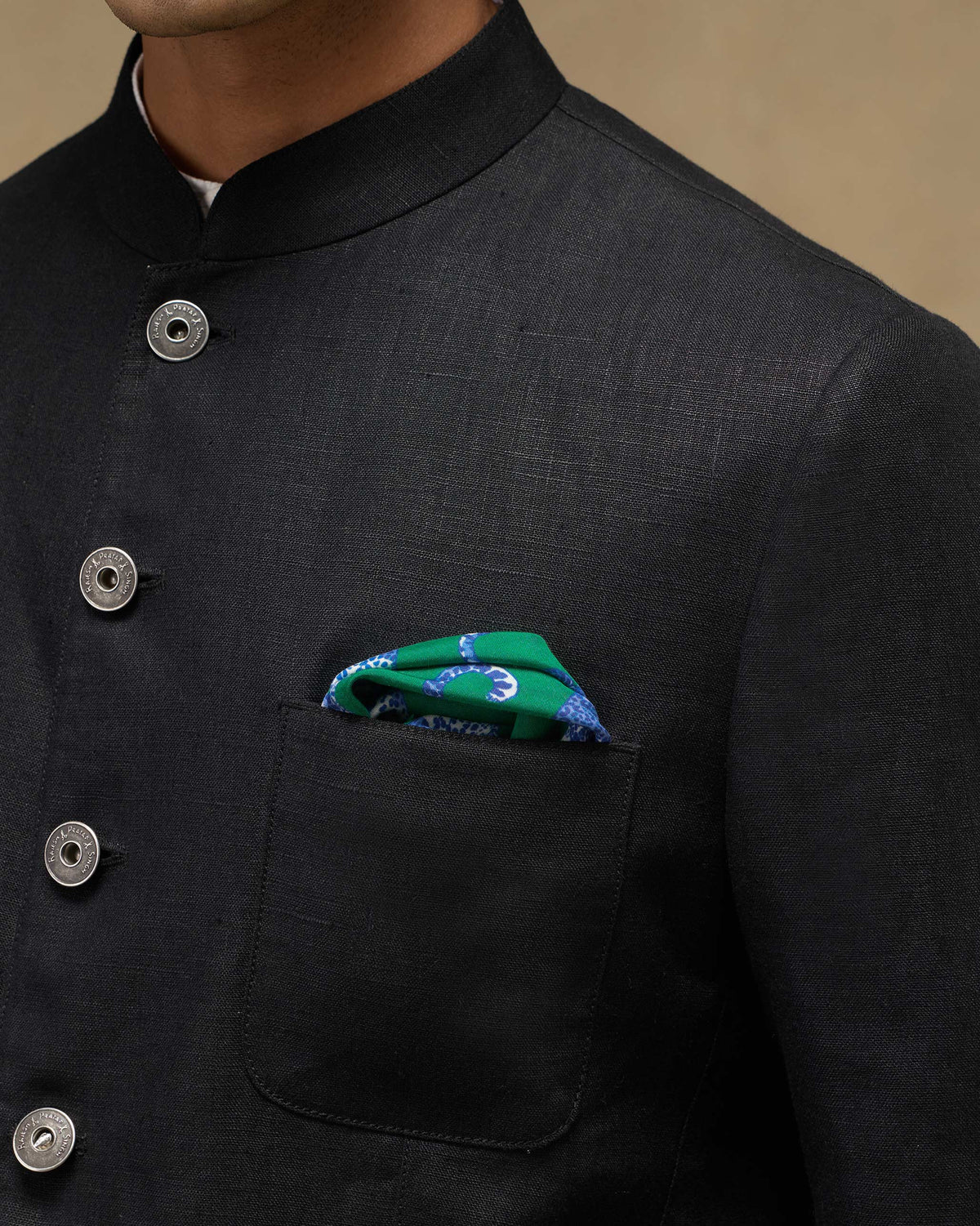Green Baagh Pocket Square with panthers tucked in a jacket pocket.