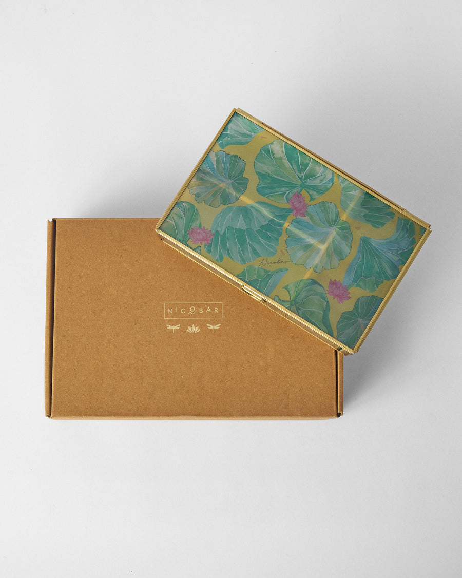 The jewellery box resting on its kraft Nicobar box