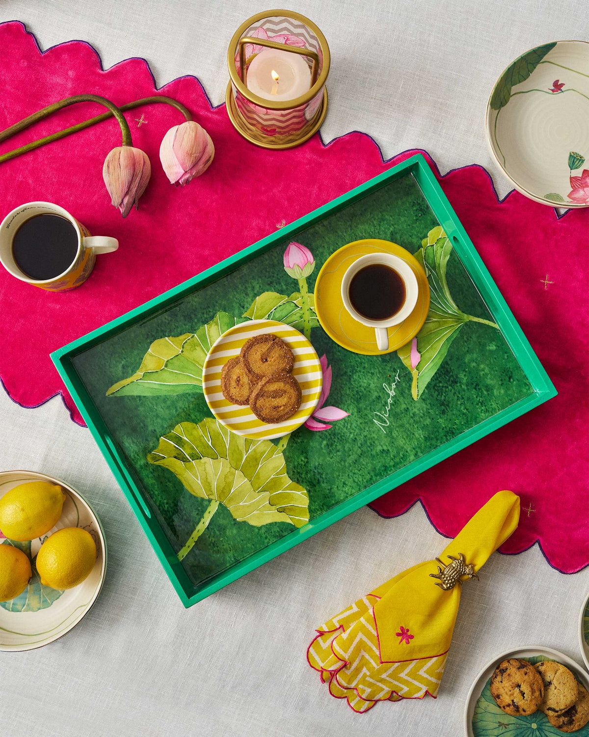 Lotus rectangular tray serving tea and cookies on a dining table.