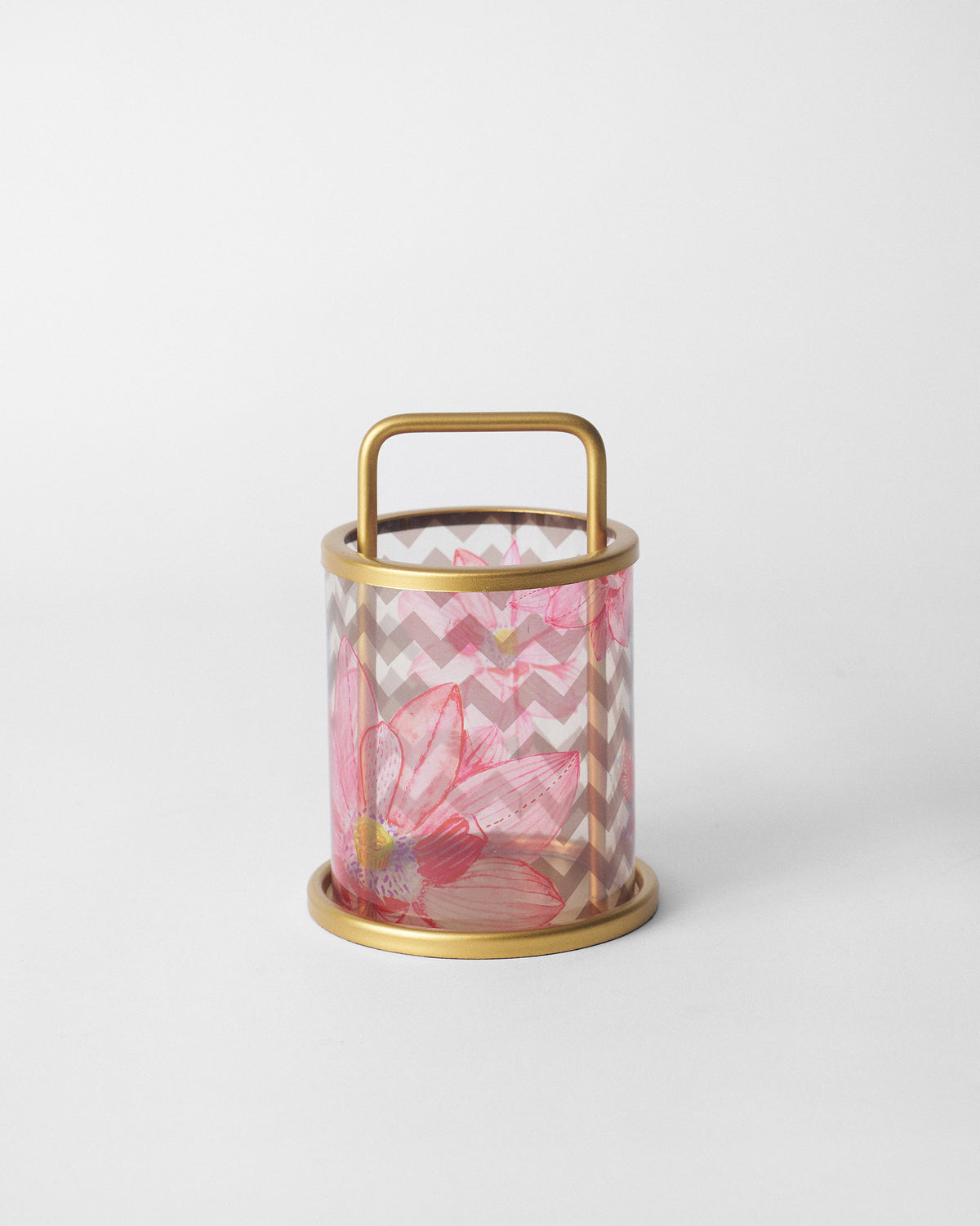 Float lantern with a pink floral and chevron print in a brass frame.