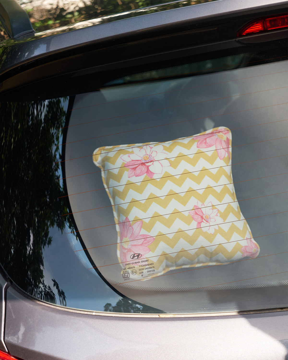 The yellow Chevron Lotus Cushion in a car.