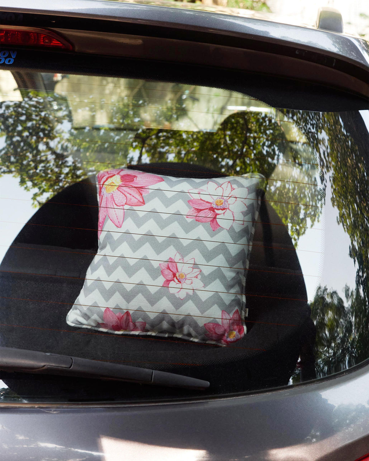The Chevron Lotus Cushion in a car's back seat.