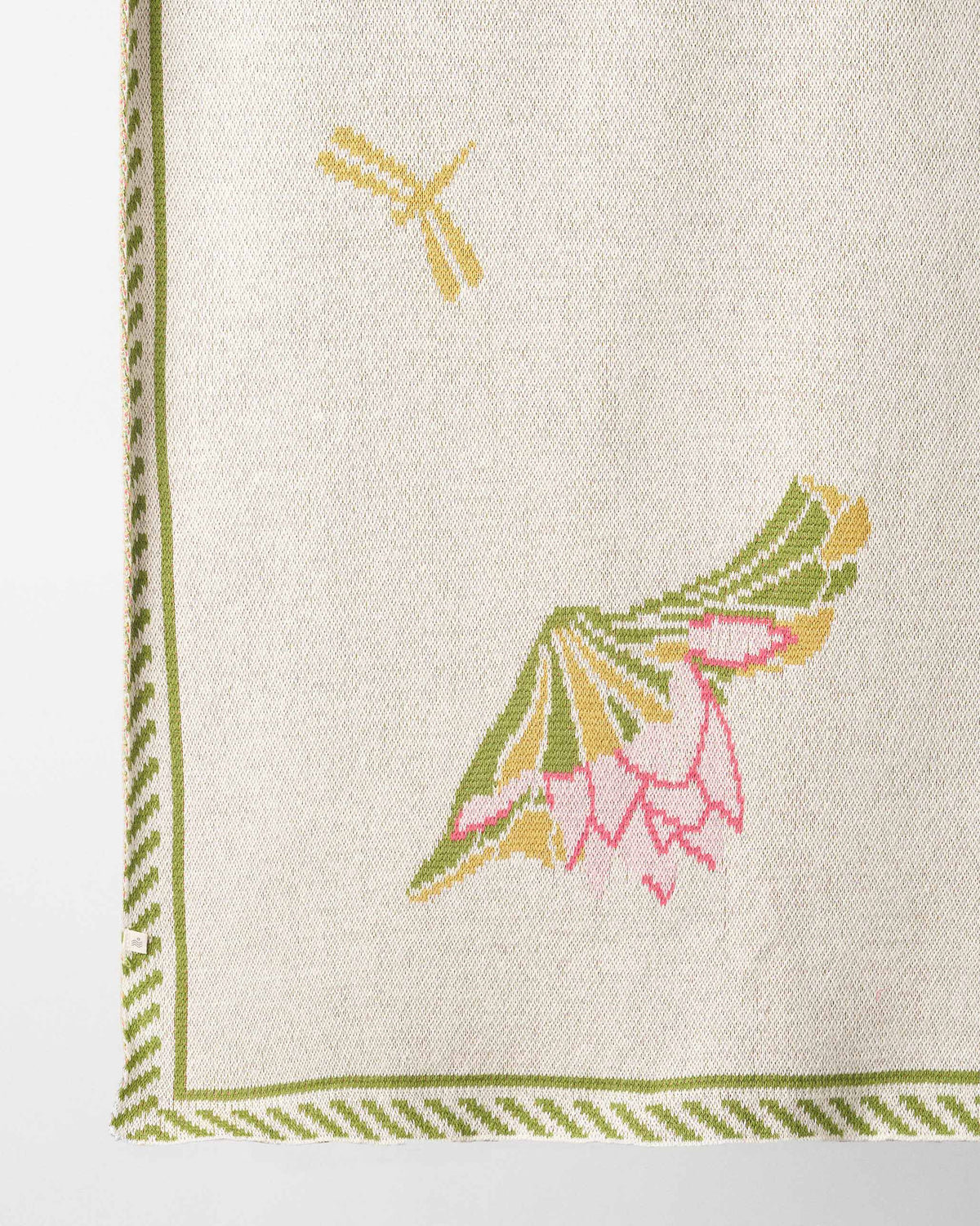 Close-up of the Lily Pond throw showing a lotus and dragonfly motif.