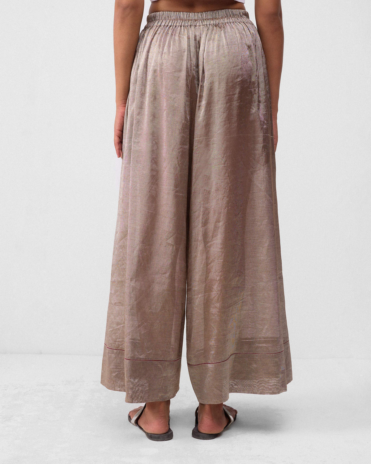 Back of silver metallic Charisma pants with a gathered elastic waist.
