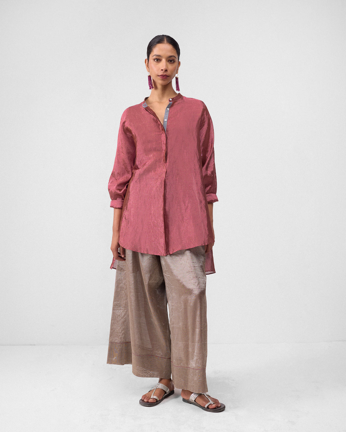 Silver metallic Charisma pants worn under a mauve tunic.