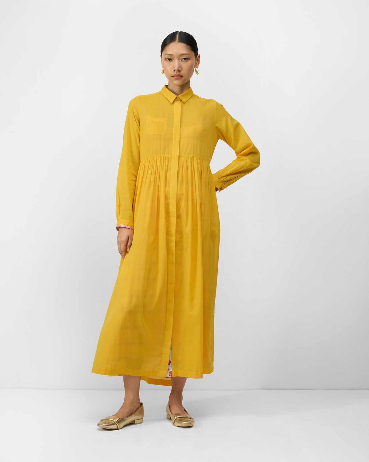 Aurora Dress front in turmeric yellow with a gathered maxi skirt.