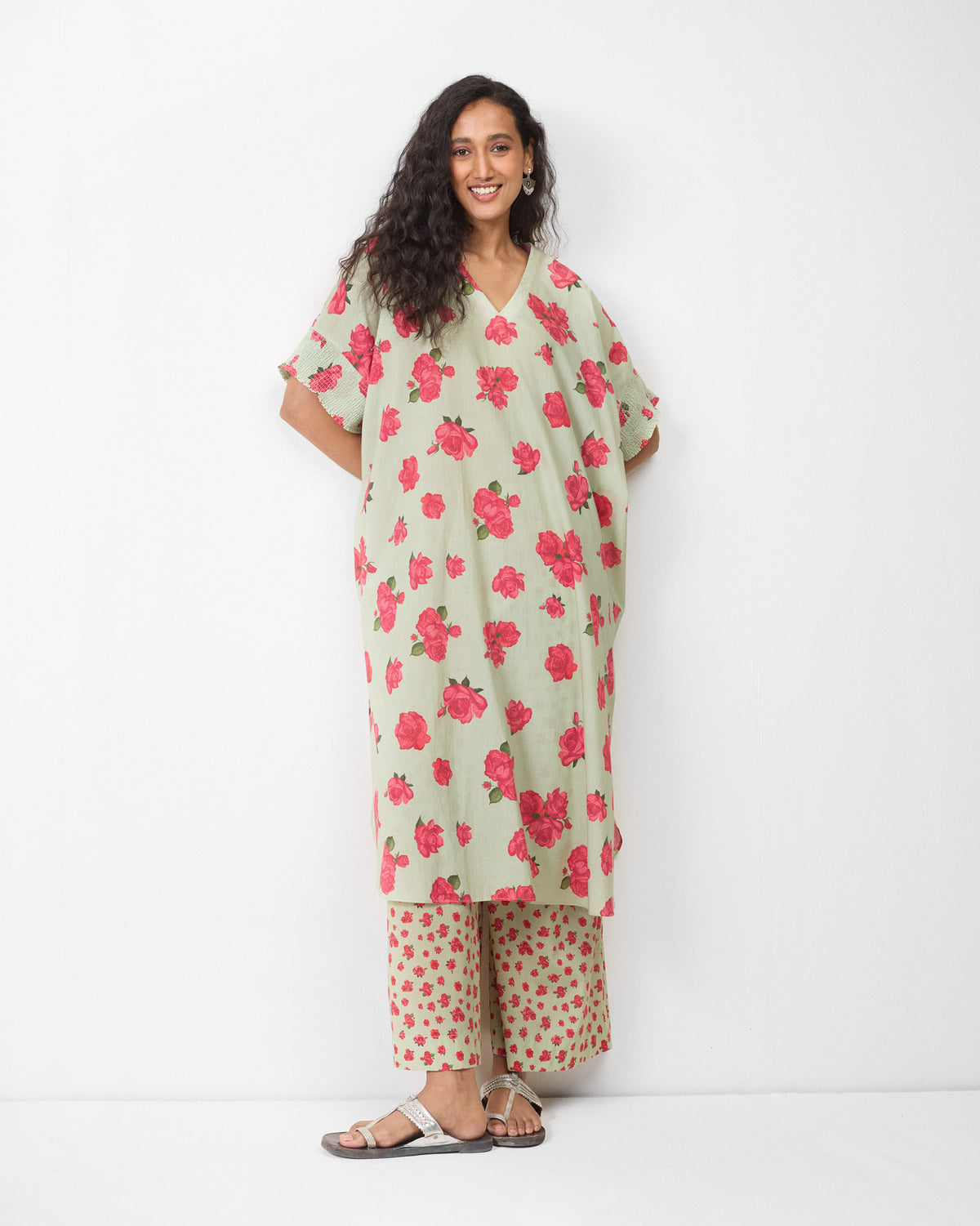Person wearing a mint Calicut kurta with pink watermelon rose print.