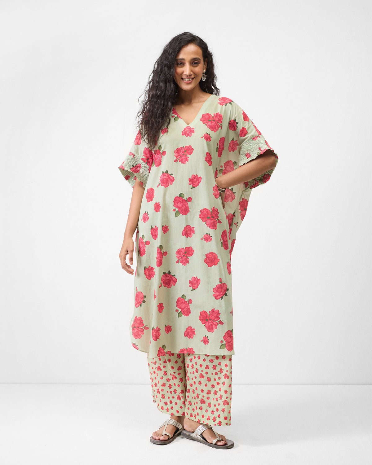 Person wearing a mint Calicut kurta with V-neck and pink rose print.