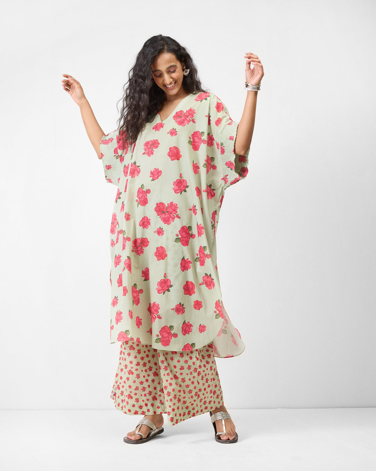 Mint Calicut kurta with pink rose print showing relaxed sleeve drape.