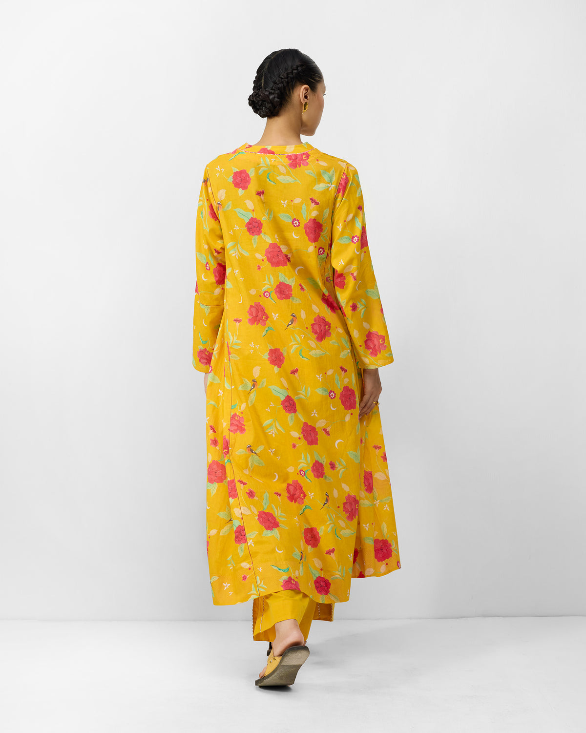 Back of a turmeric yellow Amreli kurta with watermelon peony print.