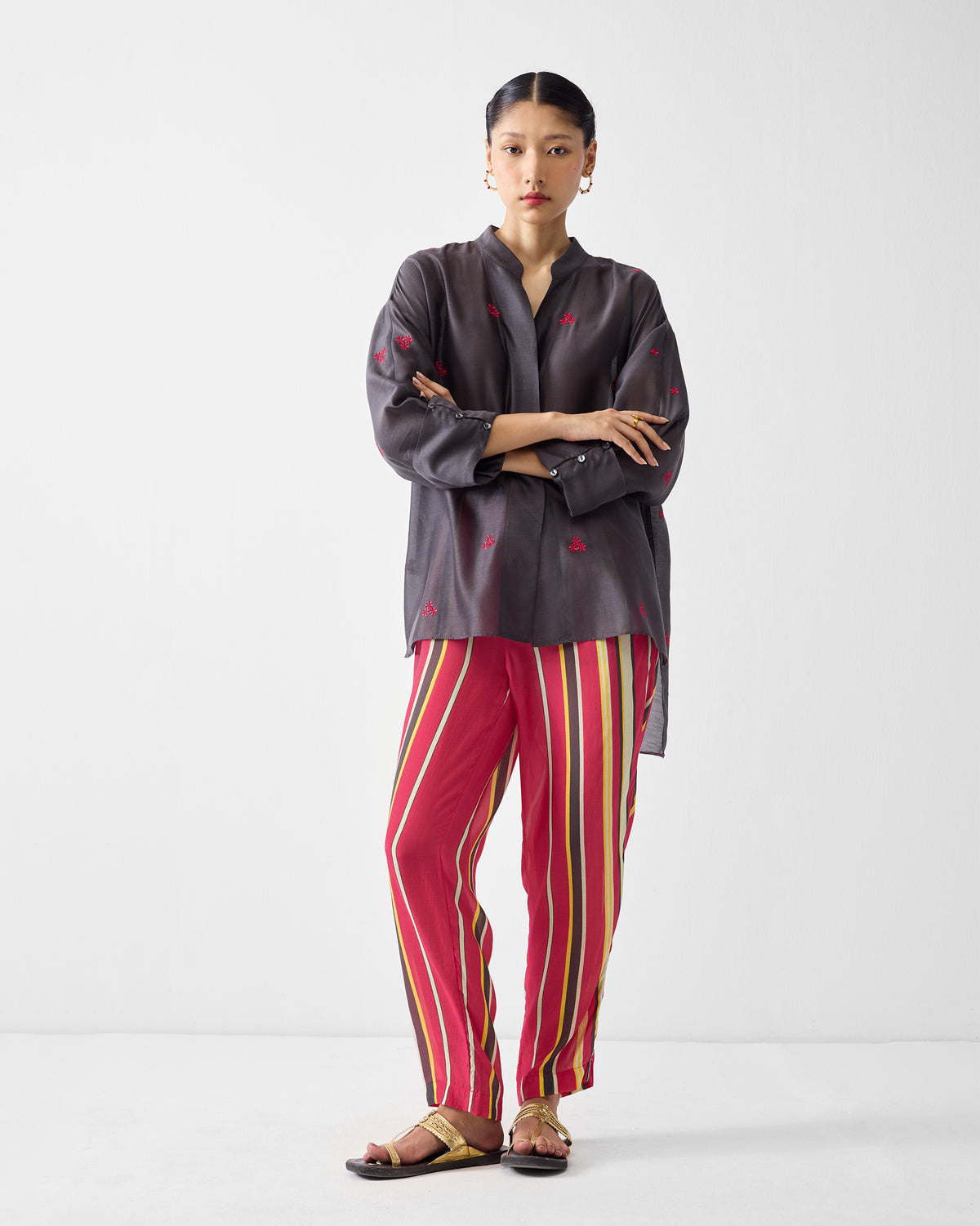 Full-length view of Narrow pants in a pink stripe print worn by a person.