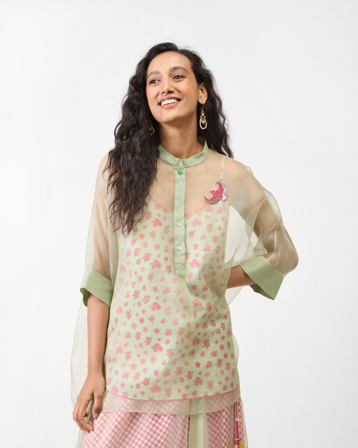 Person wearing a sheer mint Jaisalmer shirt with a mandarin collar and bird embroidery.
