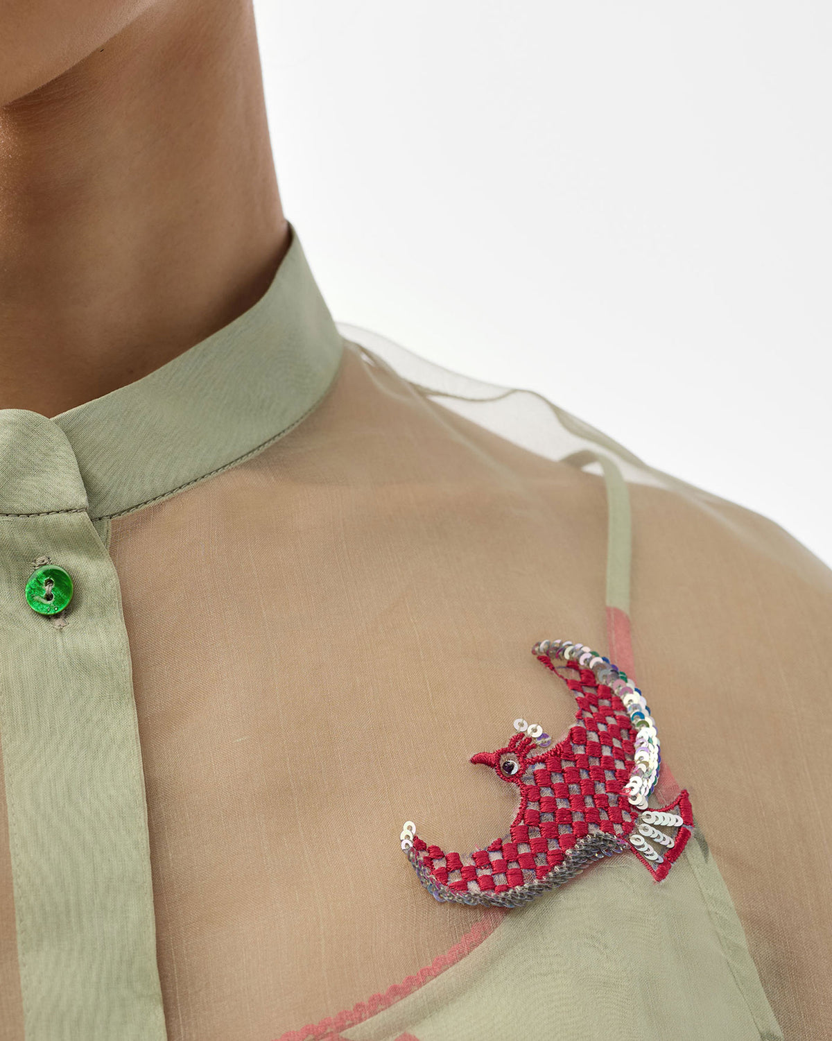 Close-up of a sequined checkered bird on a mint Jaisalmer shirt.