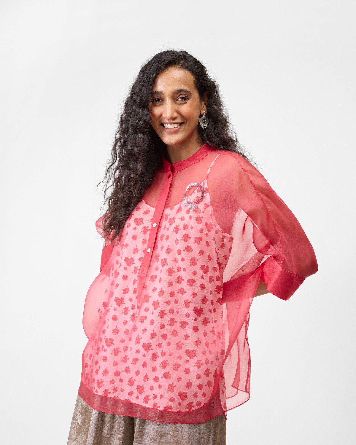 Person wearing a sheer watermelon shirt with a mandarin collar.